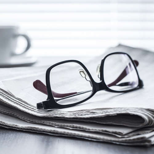 Glasses on newspaper.