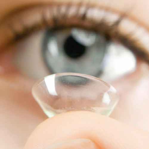 Person putting in contact lens.